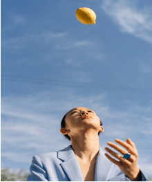 woman throwing a lemon
